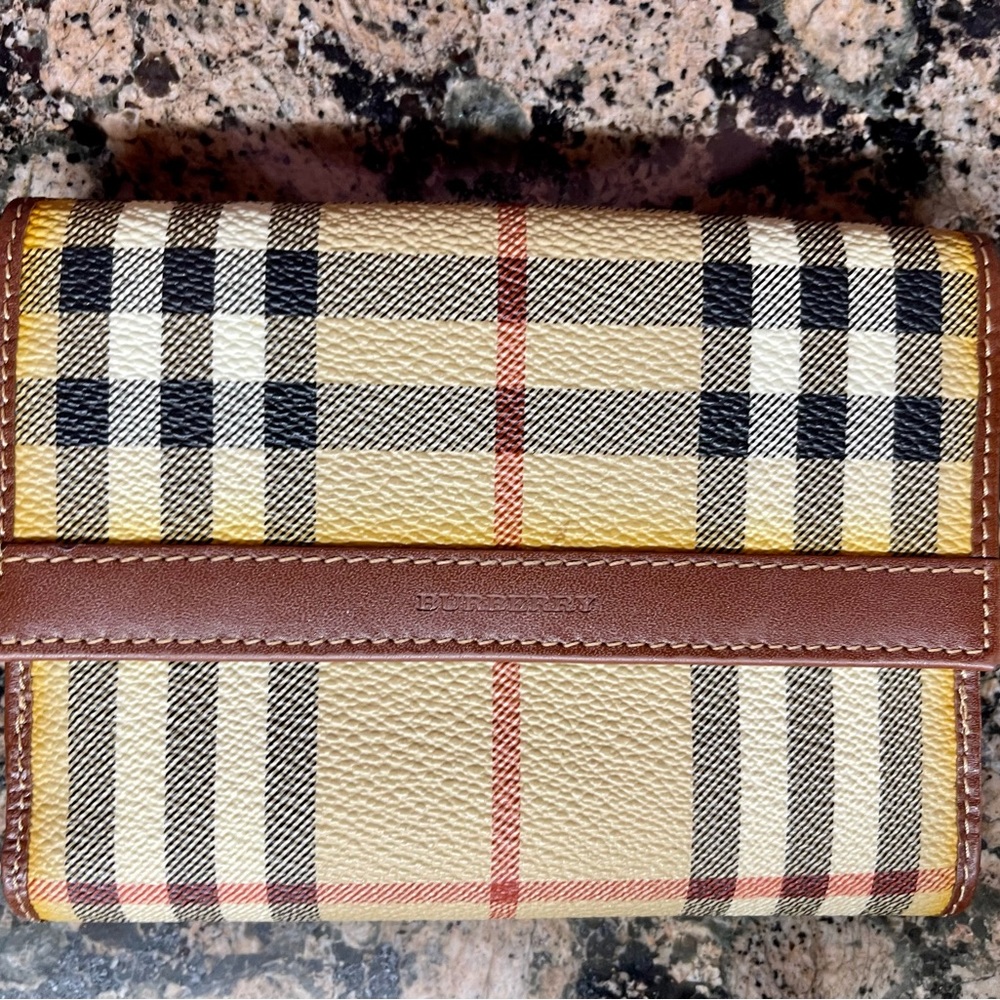 Burberry wallet with outside pocket and inside with eight slots for cards.